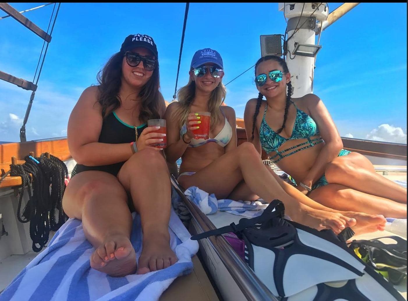 Guests smiling with drinks aboard the schooner