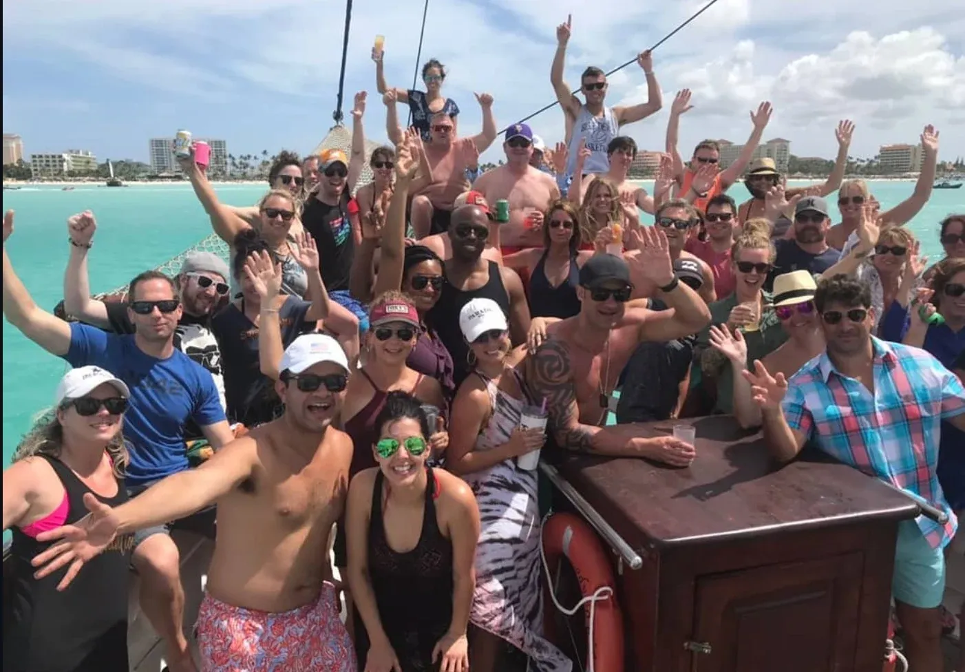 A large group of guests cheering together aboard the schooner