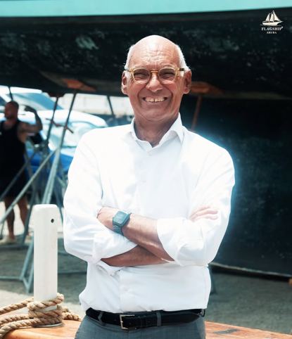 One of Flagship Aruba's owners standing beside the schooner during restoration work
