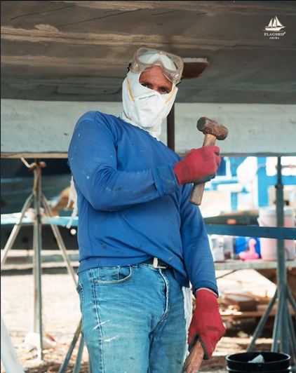A crew member preparing the hull during restoration