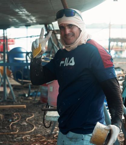 A crew member giving a thumbs up during the restoration project
